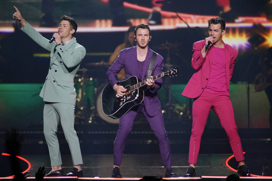 Nick Jonas, from left, Kevin Jonas, and Joe Jonas, of the Jonas Brothers, perform during their ...