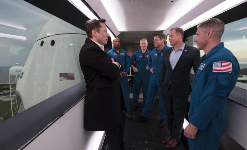 SpaceX CEO and Chief Designer Elon Musk, left, NASA astronauts Victor Glover, Doug Hurley, Bob Behnken, NASA Administrator Jim Bridenstine, and NASA astronaut Mike Hopkins are seen inside the Dragon crew access arm at Launch Complex 39A in March.